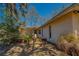 Landscaped side yard with small palm tree and low stone retaining wall for garden at 8740 Forest Lake Dr, Port Richey, FL 34668