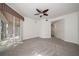 Spacious bedroom with a ceiling fan and access to the lanai through sliding glass doors at 891 Lantern Way # 13-103, Clearwater, FL 33765