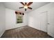 Cozy bedroom with a ceiling fan and a window view of lush greenery at 891 Lantern Way # 13-103, Clearwater, FL 33765