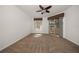 Bright bedroom with ceiling fan, large windows, and sliding glass doors to the lanai at 891 Lantern Way # 13-103, Clearwater, FL 33765