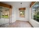 A bright breakfast nook has views of the lawn through large sliding glass door and a wide window at 891 Lantern Way # 13-103, Clearwater, FL 33765