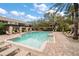 Community pool with brick surround and many chairs, offering a relaxing outdoor space at 891 Lantern Way # 13-103, Clearwater, FL 33765