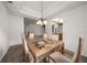Bright dining room features a glass top dining table with seating for six beneath an elegant chandelier at 891 Lantern Way # 13-103, Clearwater, FL 33765