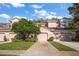 Charming townhome with a two-car garage, terracotta roof, and lush landscaping in a desirable community at 891 Lantern Way # 13-103, Clearwater, FL 33765