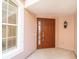 Inviting front entrance with sidelight, lantern and a secure brown door with ADT security system at 891 Lantern Way # 13-103, Clearwater, FL 33765