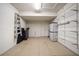 Spacious garage with storage shelving offering functional organization and a clean epoxy floor at 891 Lantern Way # 13-103, Clearwater, FL 33765
