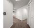 Hallway with neutral walls, carpeted floors, and easy access to a closet and the living room at 891 Lantern Way # 13-103, Clearwater, FL 33765