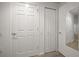 Hallway with storage closets and entryways, freshly painted in white at 891 Lantern Way # 13-103, Clearwater, FL 33765