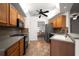 Galley kitchen features stainless steel appliances, a mosaic backsplash and tile floors at 891 Lantern Way # 13-103, Clearwater, FL 33765