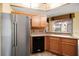 Bright kitchen featuring stainless steel refrigerator and a breakfast bar sink that looks out the window at 891 Lantern Way # 13-103, Clearwater, FL 33765