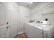 Well-equipped laundry room with modern washer and dryer units at 891 Lantern Way # 13-103, Clearwater, FL 33765