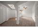 Open-concept living room and entryway with carpeted floors, a ceiling fan, and neutral wall colors at 891 Lantern Way # 13-103, Clearwater, FL 33765