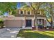 Charming two-story home featuring a two-car garage and well-maintained landscaping at 9102 Tollison Loop, Land O Lakes, FL 34638