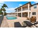 Backyard oasis with a sparkling pool, lounge chairs, an outdoor kitchen, and a covered patio area at 9402 59Th N St, Pinellas Park, FL 33782