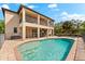 Relaxing backyard pool and patio area with lounging chairs and a covered balcony at 9402 59Th N St, Pinellas Park, FL 33782