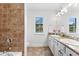 Bright bathroom featuring a double vanity with granite countertops and a separate tiled shower area at 9402 59Th N St, Pinellas Park, FL 33782