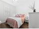 Inviting bedroom with wood floors, white plantation shutters, and calming decor at 9402 59Th N St, Pinellas Park, FL 33782