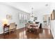 Cozy dining room features wood floors, plantation shutters, and a stylish chandelier at 9402 59Th N St, Pinellas Park, FL 33782