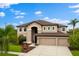 Beautiful two-story home with a three-car garage, manicured lawn, and lovely landscaping at 9402 59Th N St, Pinellas Park, FL 33782
