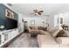 Comfortable living room featuring a sectional sofa, a ceiling fan, and a media center at 9402 59Th N St, Pinellas Park, FL 33782