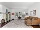 Comfortable living room with hardwood floors, plantation shutters, and a large area rug at 9402 59Th N St, Pinellas Park, FL 33782