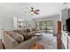 Spacious living area featuring a ceiling fan, hardwood floors, and access to the lanai at 9402 59Th N St, Pinellas Park, FL 33782