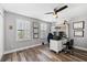 Well-lit home office with modern desk setup, hardwood flooring, and large windows with natural light at 9402 59Th N St, Pinellas Park, FL 33782