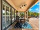 Outdoor patio featuring ceiling fans, a dining table and seating, and sliding glass doors at 9402 59Th N St, Pinellas Park, FL 33782
