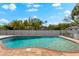 Sparkling blue swimming pool with brick trim, surrounded by lush landscaping at 9402 59Th N St, Pinellas Park, FL 33782