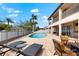 Stunning backyard pool area with lounge chairs and outdoor dining for relaxation and entertainment at 9402 59Th N St, Pinellas Park, FL 33782