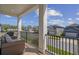 Relaxing outdoor balcony with comfortable seating, neighborhood views, and a black metal railing at 9817 Coneflower Ct, Land O Lakes, FL 34637