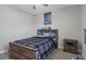 Cozy bedroom with rustic wood bed frame, storage headboard and a Sonic the Hedgehog poster above the bed at 9817 Coneflower Ct, Land O Lakes, FL 34637