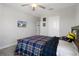 Comfortable bedroom with a rustic wood bed frame and a wall-mounted TV for entertainment with two closets at 9817 Coneflower Ct, Land O Lakes, FL 34637