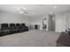 The carpeted bonus room includes a wet bar and theatre seating, creating a comfortable entertainment space at 9817 Coneflower Ct, Land O Lakes, FL 34637
