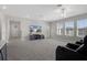 This bonus room is carpeted with a TV and lots of natural light from the many windows at 9817 Coneflower Ct, Land O Lakes, FL 34637