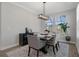 Bright dining room features an elegant chandelier, a sideboard, and views of the neighborhood at 9817 Coneflower Ct, Land O Lakes, FL 34637