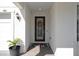 Home's entryway featuring a decorative wreath on the front door and a 'Hello' doormat at 9817 Coneflower Ct, Land O Lakes, FL 34637