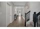 Hallway displaying neutral walls, wood-look flooring, and stairway at 9817 Coneflower Ct, Land O Lakes, FL 34637