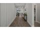Stylish hallway showcasing wood-look flooring, neutral walls, and modern decor at 9817 Coneflower Ct, Land O Lakes, FL 34637