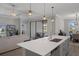 Open concept kitchen features a central island with sink and dishwasher overlooking the living room with backyard access at 9817 Coneflower Ct, Land O Lakes, FL 34637