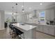 Bright kitchen featuring a large island with seating, stainless appliances, and an open floorplan to the dining area at 9817 Coneflower Ct, Land O Lakes, FL 34637