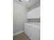 Bright laundry room with washer and dryer, gray walls and tile floors at 9817 Coneflower Ct, Land O Lakes, FL 34637