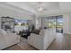 Cozy living room with neutral furniture, open shelving, and a view of the backyard at 9817 Coneflower Ct, Land O Lakes, FL 34637