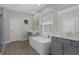 Bright main bathroom features double vanity, a soaking tub, and a glass-enclosed shower at 9817 Coneflower Ct, Land O Lakes, FL 34637