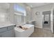 Bright main bathroom boasts double vanity, a soaking tub, and easy access to main bedroom at 9817 Coneflower Ct, Land O Lakes, FL 34637