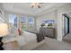 Spacious main bedroom showcases tray ceiling, television, and lots of natural light at 9817 Coneflower Ct, Land O Lakes, FL 34637