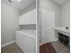 Mudroom features a washer and dryer, overhead cabinets and door with welcome mat, bench and a shoe rack at 9817 Coneflower Ct, Land O Lakes, FL 34637