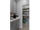 Walk-in pantry featuring shelving with an assortment of groceries, next to coffee bar at 9817 Coneflower Ct, Land O Lakes, FL 34637