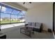 Enclosed patio with stylish outdoor furniture and string lights, providing an inviting space for relaxing and entertaining at 9817 Coneflower Ct, Land O Lakes, FL 34637