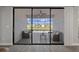 Spacious enclosed patio with neutral seating, a coffee table, large sliding glass doors, and views of the backyard at 9817 Coneflower Ct, Land O Lakes, FL 34637
